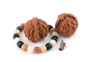 Miniaturized world of old man play with walnuts and bracelets