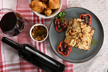 roast cod with salad wine and olive oil Portuguese fish bacalhoada typical Portuguese food