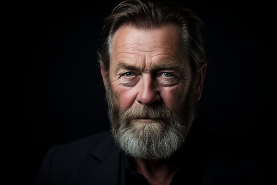 Portrait of a handsome senior man with long beard and mustache. Studio shot.
