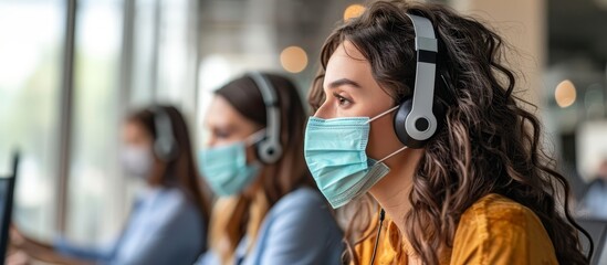 Female call center agents are wearing face masks to protect themselves while working and talking to customers during the coronavirus outbreak.