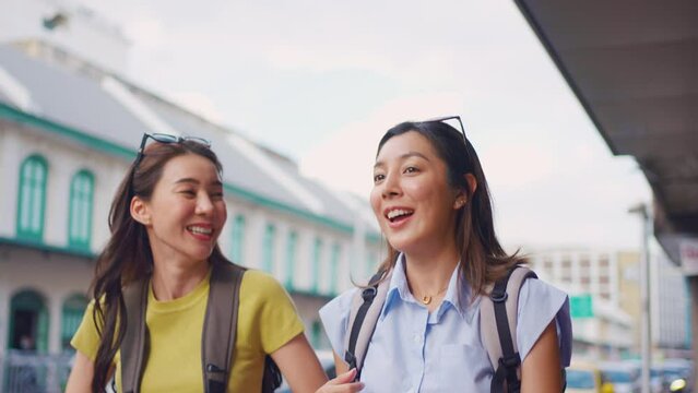 Asian beautiful women backpacker friend traveling outdoor in the city. 
