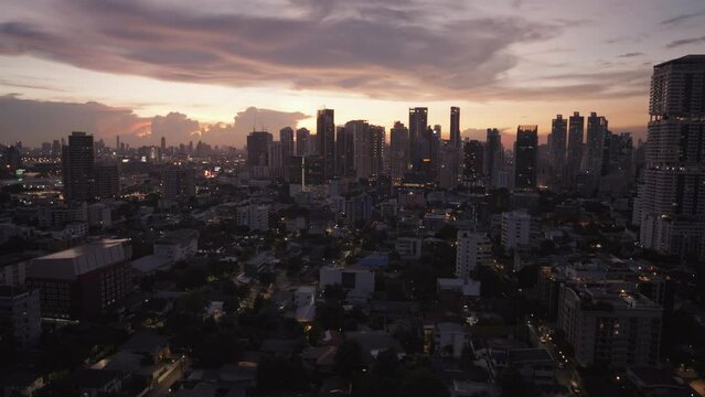 Sunset in Phrom Phong Area Bangkok City, Thailand with the background of Cityscape luxury hotels and condominium buildings