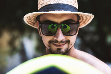 Portrait of Attractive and Confident Young Adult Macho Man with a Beach Ball, Hat and Sunglasses ...
