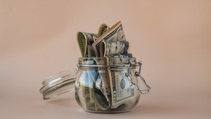 Dollar banknote saving money in glass jar. Consumption and economy Collecting money. Tips....