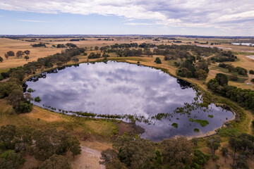 Aerial view of a treelined waterhole in the Australian outback