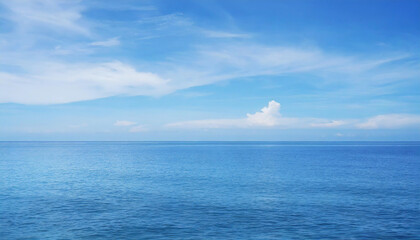 Fototapeta premium Tranquil Seascape under a Clear Blue Sky with Fluffy Clouds on a Sunny Summer Day