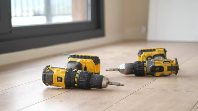 An electric screwdriver is on the floor, 