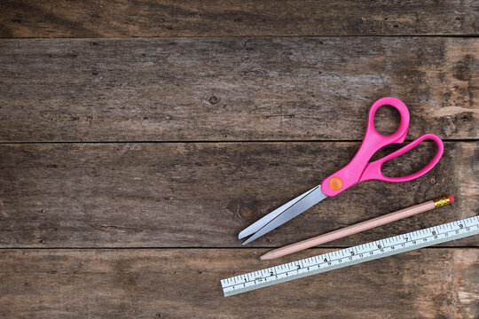 Top view Arts and Crafts background scissors pencil ruler rustic wooden table setting copy space 