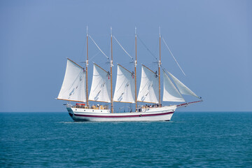 A beautiful white sail tour boat in the lake Michigan.