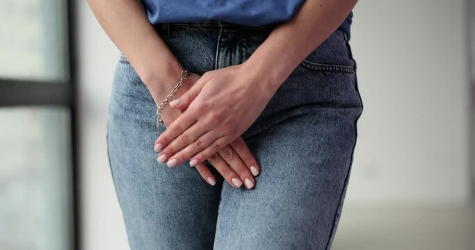Pain due to bowel incontinence and woman hand holds perineum