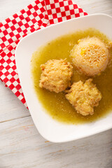 Cutlets of shredded chicken meat fried in batter egg, in Mexico known as Tortitas de Pollo, bathed with green sauce and accompanied by rice. Traditional and very popular homemade recipe in Mexico.