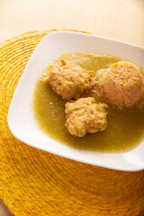 Cutlets of shredded chicken meat fried in batter egg, in Mexico known as Tortitas de Pollo, bathed with green sauce and accompanied by rice. Traditional and very popular homemade recipe in Mexico.