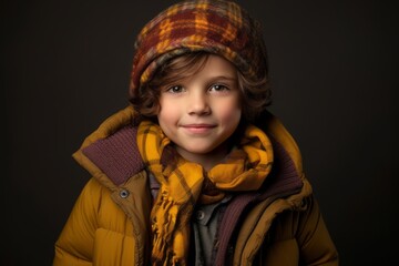 Portrait of a cute little boy in warm winter clothes. Studio shot.