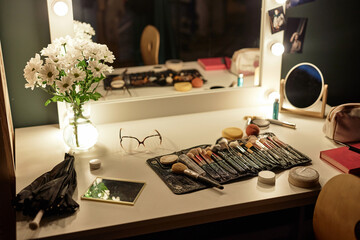 Background image of makeup brushes over vanity table with lights at backstage in theater, copy space - obrazy, fototapety, plakaty