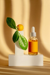 Serum is orange in transparent glass bottle with white dropper lid on white podium-stand. Mockup of...