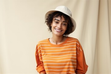 Beautiful african american young woman with curly hair wearing a hat