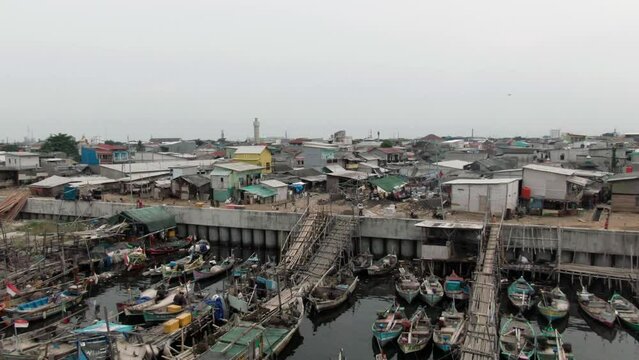Aerial footage of boats docked at the pier in a slum and densely populated area in Cilingcing, Tanjung Priok, North Jakarta | Perahu kayu bersandar di Dermaga Wilayah kumuh padat penduduk 4K Drone