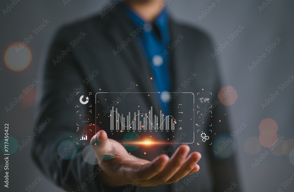 Poster businessman or analyst working with business analytics and data management system on virtual screen,