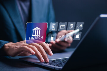 Fintech and digital money concept. Businessman use laptop with virtual fintech icons for digital banking, internet payment, online shopping, financial technology.