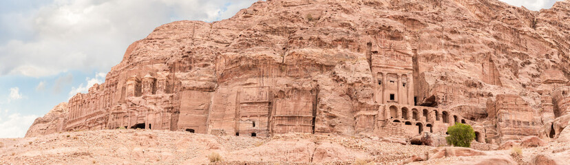 Majestic facades of tombs carved by Nabatean craftsmen into rock in Nabatean Kingdom of Petra in...