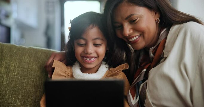 Tablet, search and mother and daughter on a sofa with cartoon, streaming or gaming in their home together. Digital, love and mom with girl child in a living room with app for playing, video or ebook