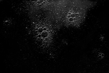 Air bubbles in the water background.Abstract oxygen bubbles in the sea.Water bubbles isolate on black background.Black and white tone style.