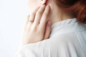 Serene Woman Touching Her Neck in Soft Light