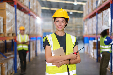 The photograph captures a Western-looking, fair-skinned female warehouse officer striking a confident pose for the camera inside the warehouse.