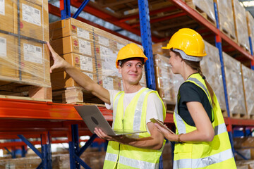 The male and female warehouse officers are currently working together to conduct a thorough stock inventory within the warehouse