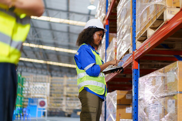 The warehouse officer, who is female, is presently conducting an inspection of the inventory within...