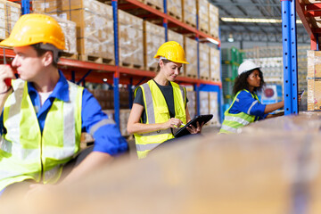 The warehouse officer, who is female, is presently conducting an inspection of the inventory within the warehouse.