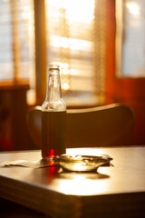 Obraz na płótnie Canvas Beer and an ashtray on a dinner table