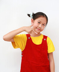 Portrait of Asian girl child pointing down on white background.