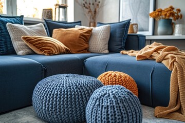 Near the dark blue corner sofa are two crocheted poufs. Generative Ai.