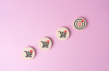 Wooden label with shopping cart icon and jumping line to target dartboard. Increase higher profit...