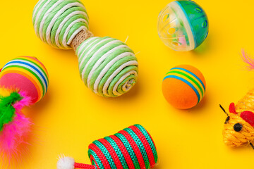 Pet toys on yellow background studio shot
