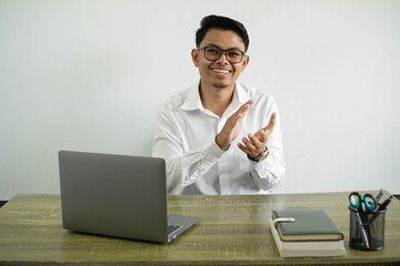 smiling young asian businessman in a workplace applauding after presentation in a conference, wear white shirt with glasses isolated