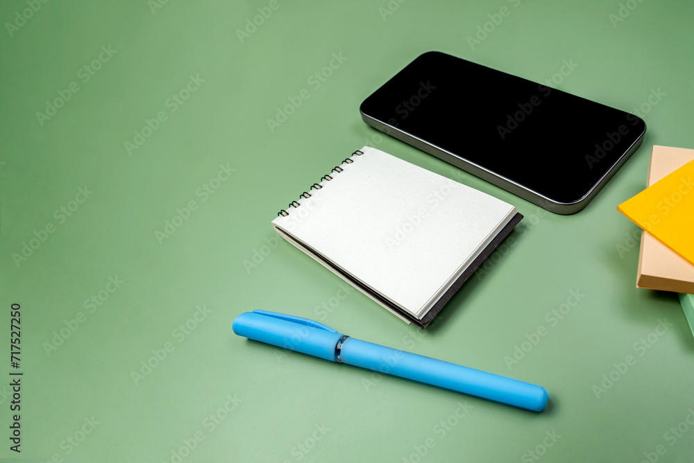 Aufkleber closeup view of mobile phone with blank screen and an empty notebook and note paper