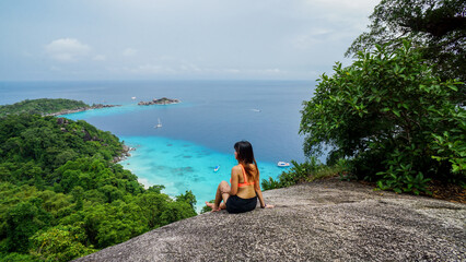 Asian female stand on viewpoint sailing rock in Similan island Koh 4 view piont. Freedom traveler...