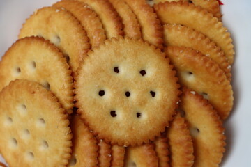 Salted crackers or biscuits served in black platter, tea time snack