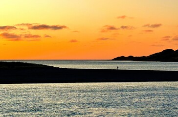 A golden sunset over the sea in Raglan, New Zealand