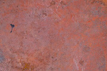 Red steel plate full of rust and scratches for background and wallpaper with copy space. Old metal surface.