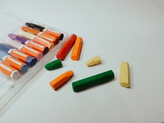 Colored pencils or crayons with white canvas.