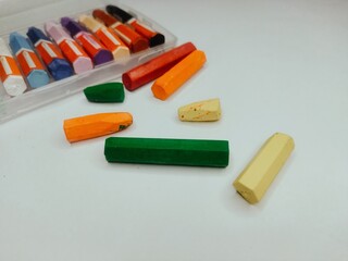 Colored pencils or crayons with white canvas.