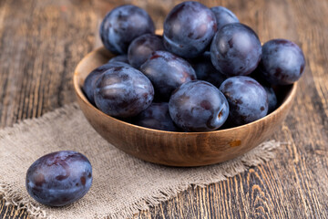 Wet purple plum on the table, fresh harvest