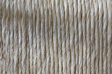 background of natural straw rope on a spool with parallel threads