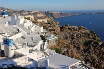 Whitewashed houses with terraces and pools and a beautiful view in Imerovigli on Santorini island,...