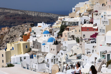 Whitewashed buildings on the edge of the caldera cliff in Oia village, Santorini, Greece