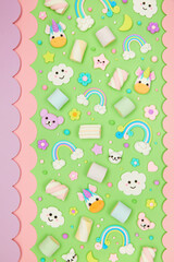 Trendy pastel green kawaii flyer, banner background design template with cute air plasticine handmade cartoon animals, unicorns, stars, rainbows pattern. Top view, flat lay. Candycore, fairycore.