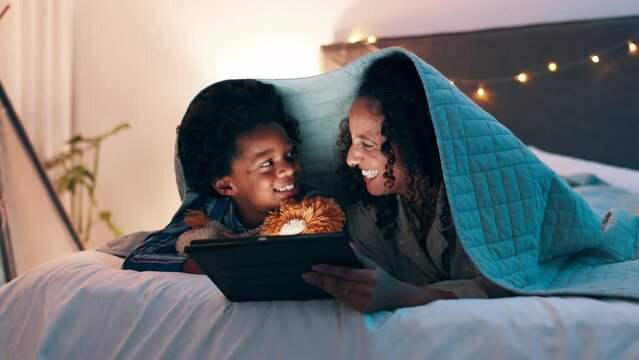 Tablet, search and mother and son on a bed with cartoon, movie or streaming funny video in their home. Digital, app and mom with kid in a bedroom for online comic, love and bonding with blanket fort
